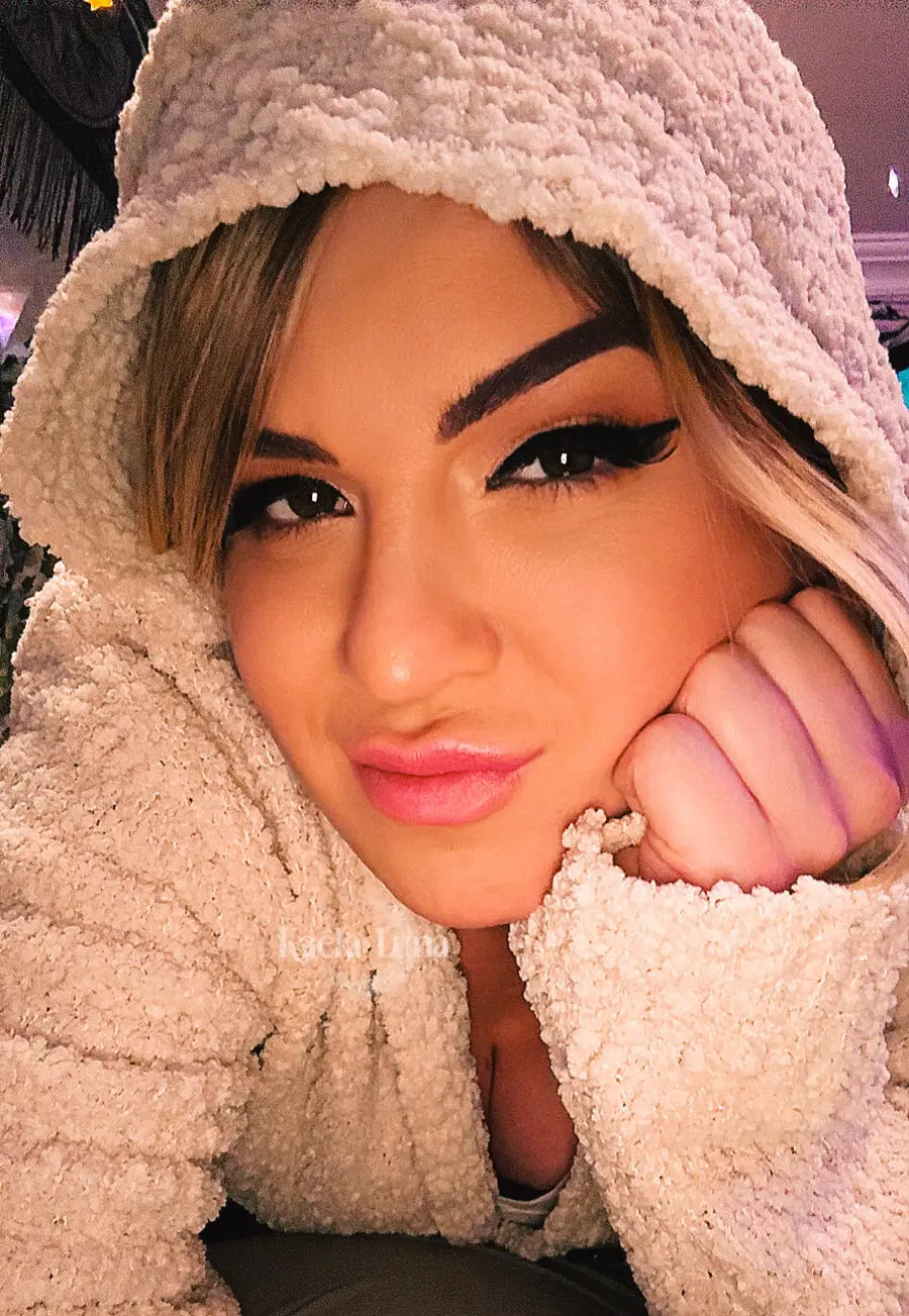 Kaela Luna in a fluffy hood, resting her chin on her hand